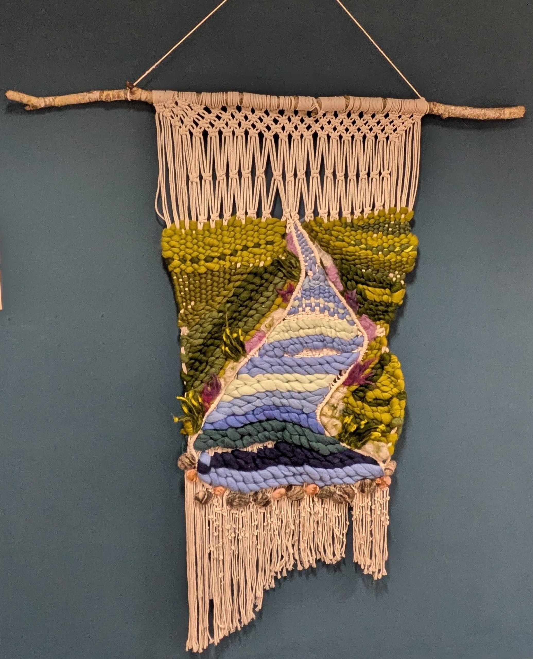 Penny Dixon: In Flow wall hanging made with Merino wool, hand-woven macraweave, macramé knots, textured yarns, hand-felted wool pebbles, sculptural felted flora, natural branch